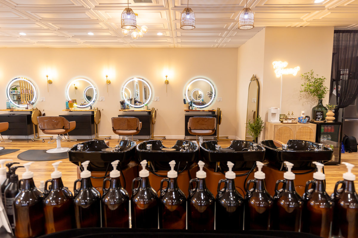 Backbar with professional product bottles at Solace Salon