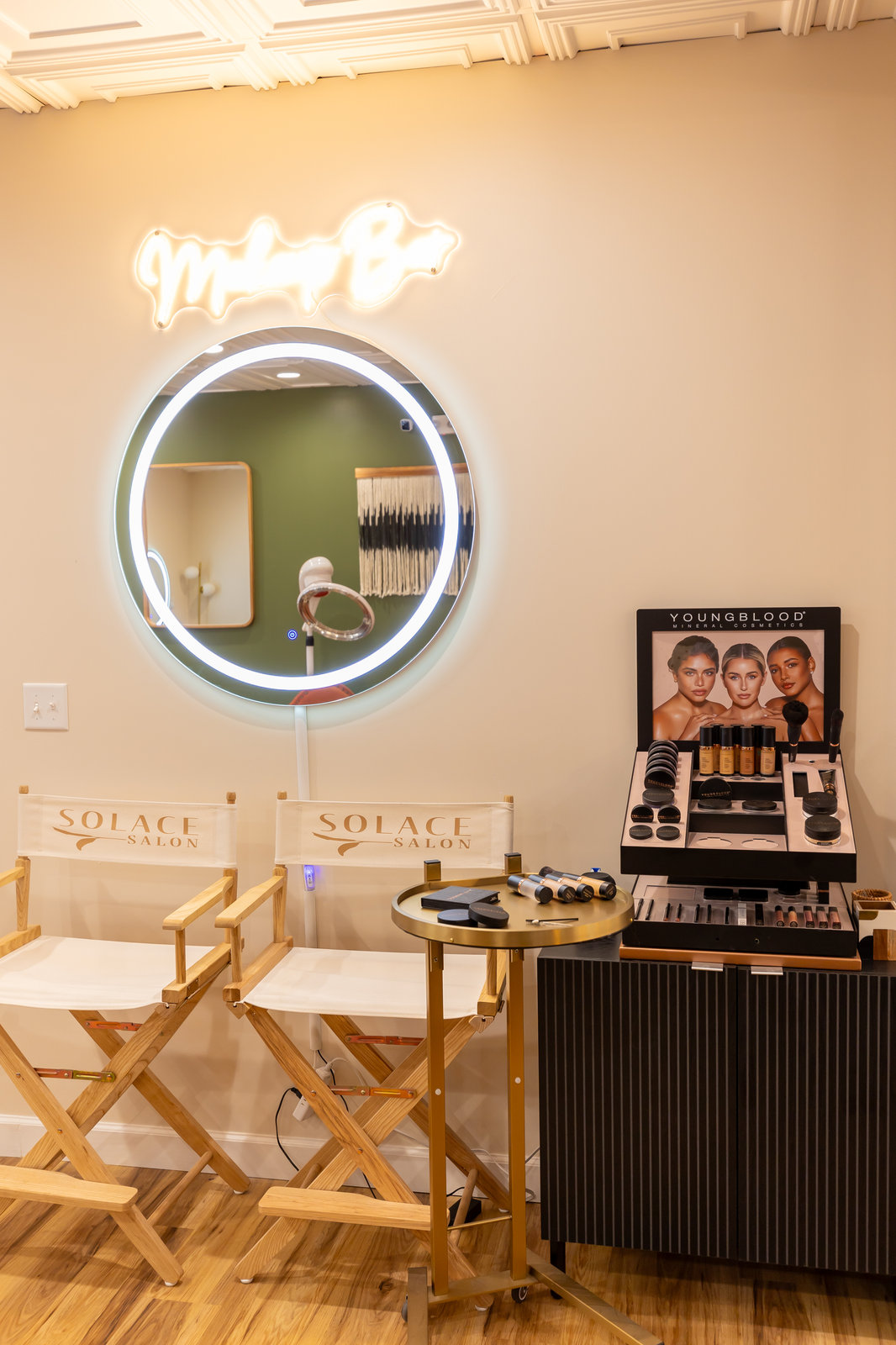 Makeup station with neon sign at Solace Salon