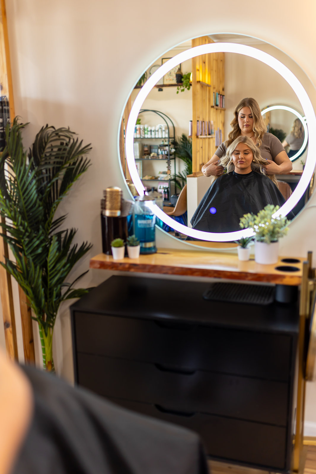 Mirror station with a stylist at Solace Salon