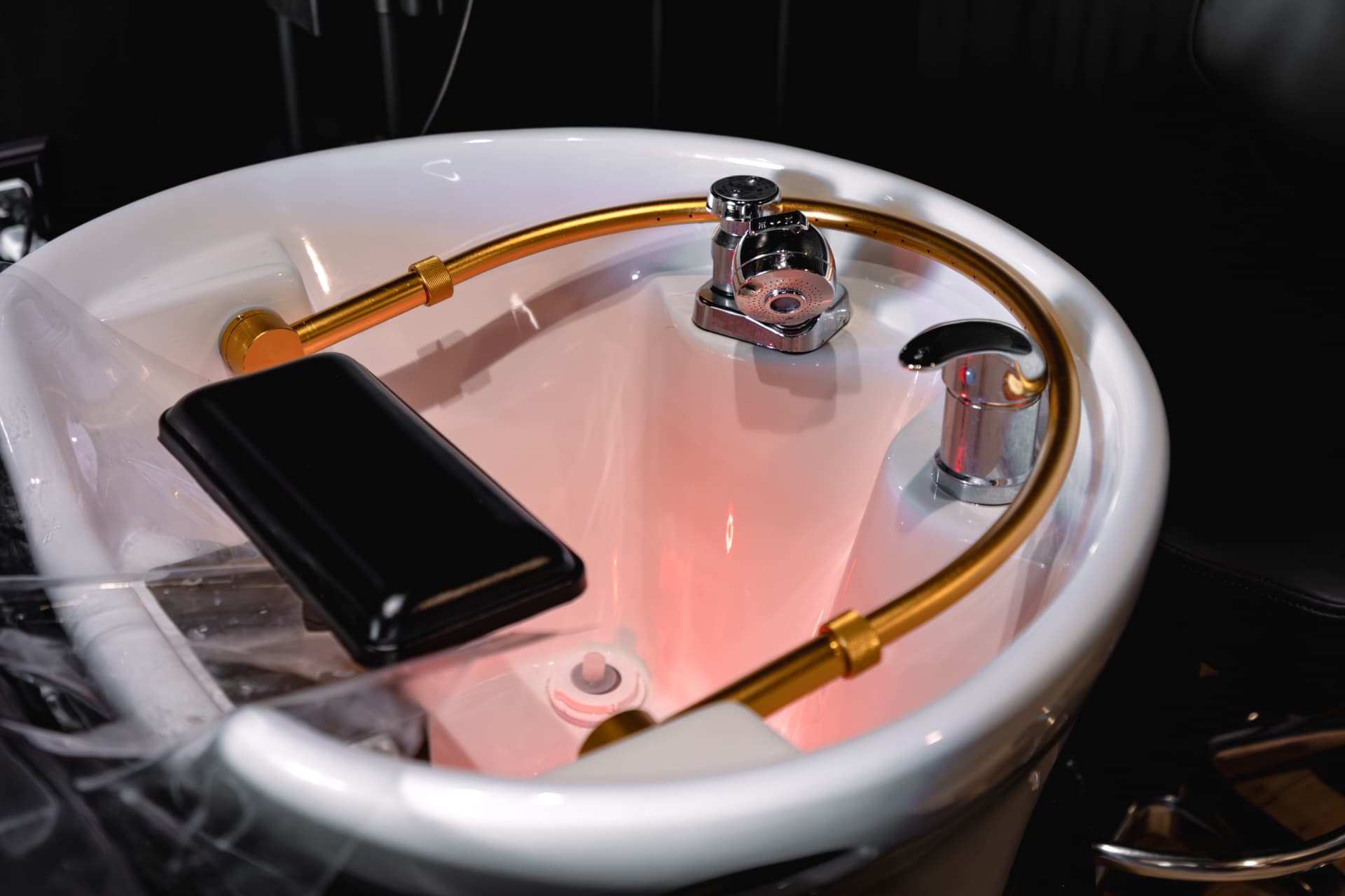 Head spa basin with gold halo rinse at Solace Salon
