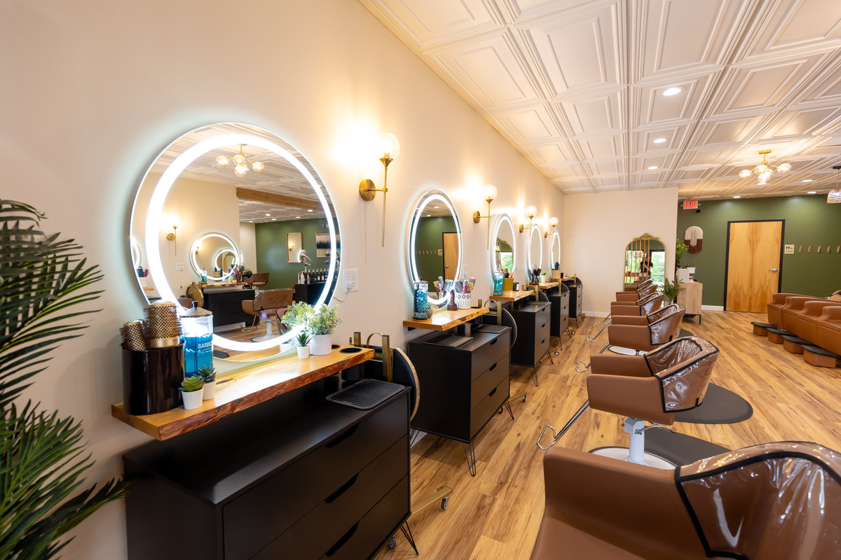 Row of styling mirrors with ring lights at Solace Salon