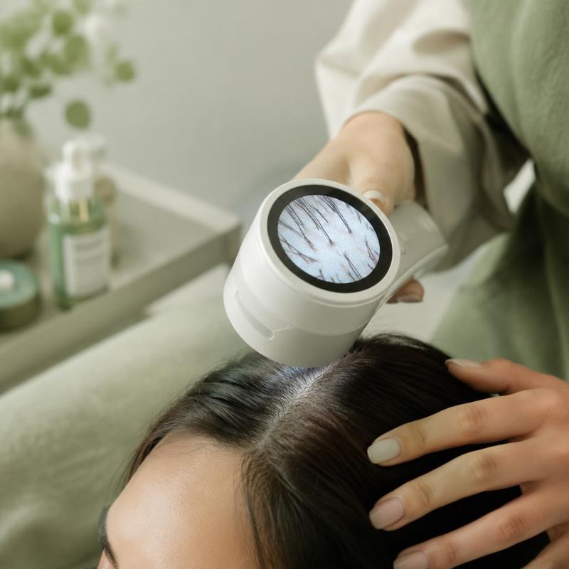 Professional scalp scope examining a client's scalp